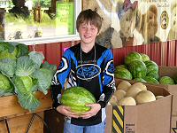 A happy customer with one of our Seedless Watermellons!